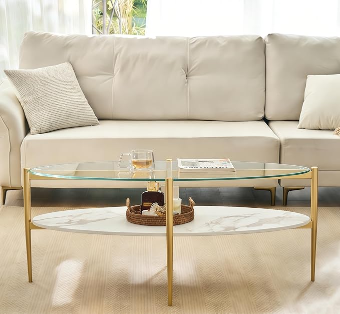 Shrine Oval Coffee Table, Mid-Century Modern Design, 2-Tier Structure, Clear Glass Top and White MDF Shelf, 47" D x 21" W x 17" H, Sleek Conical Metal Legs with Gold Finish